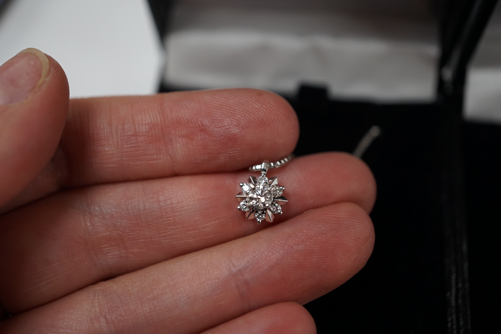 A modern white metal (stamped pt850) and diamond cluster set pendant necklace, 42cm, gross weight 6.3 grams, together with a modern 750 and diamond cluster set pendant, on a white metal ball link chain, 48cm. Condition -